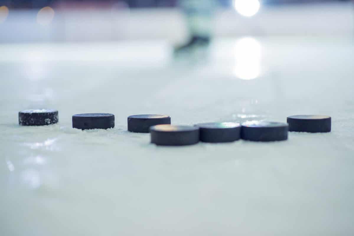 Selective focus shot of ice hockey pucks on the ice